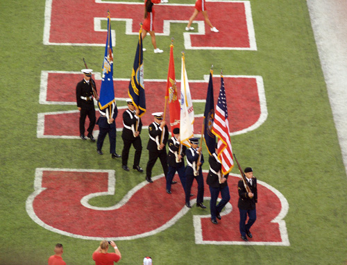 the flag bearers leaving the field at a nebraska cornhusker football game (after the national anthem was sung)