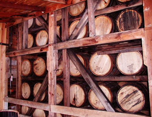 barrels of bourbon aging at a distillery in kentucky