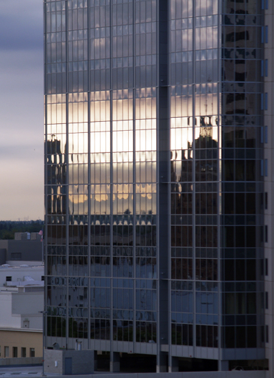reflection of a bridge in the shiny windows of a modern building in sacramento california